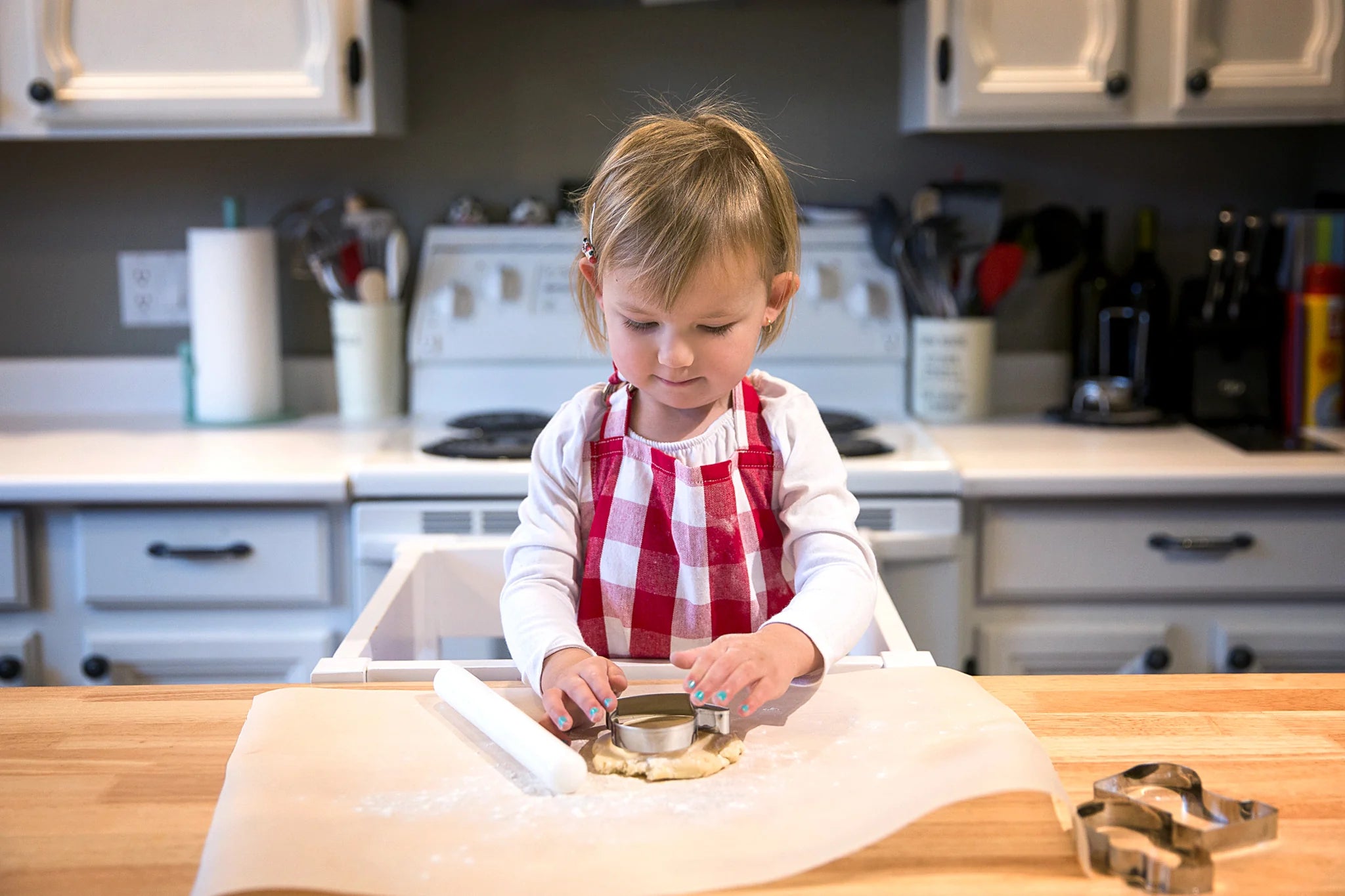 Child making cookies on parchment paper